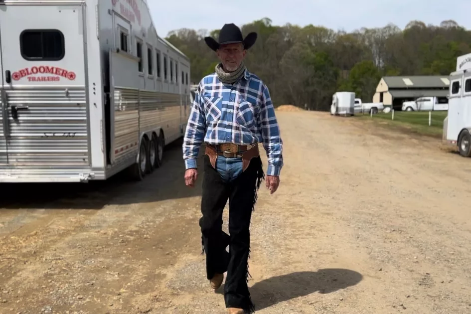 Ken Sharpe walking between horse trailers